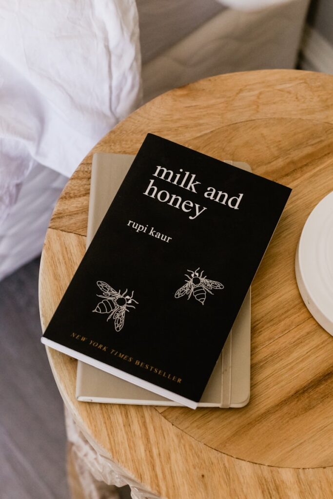 Black book titled "milk and honey" on table.
